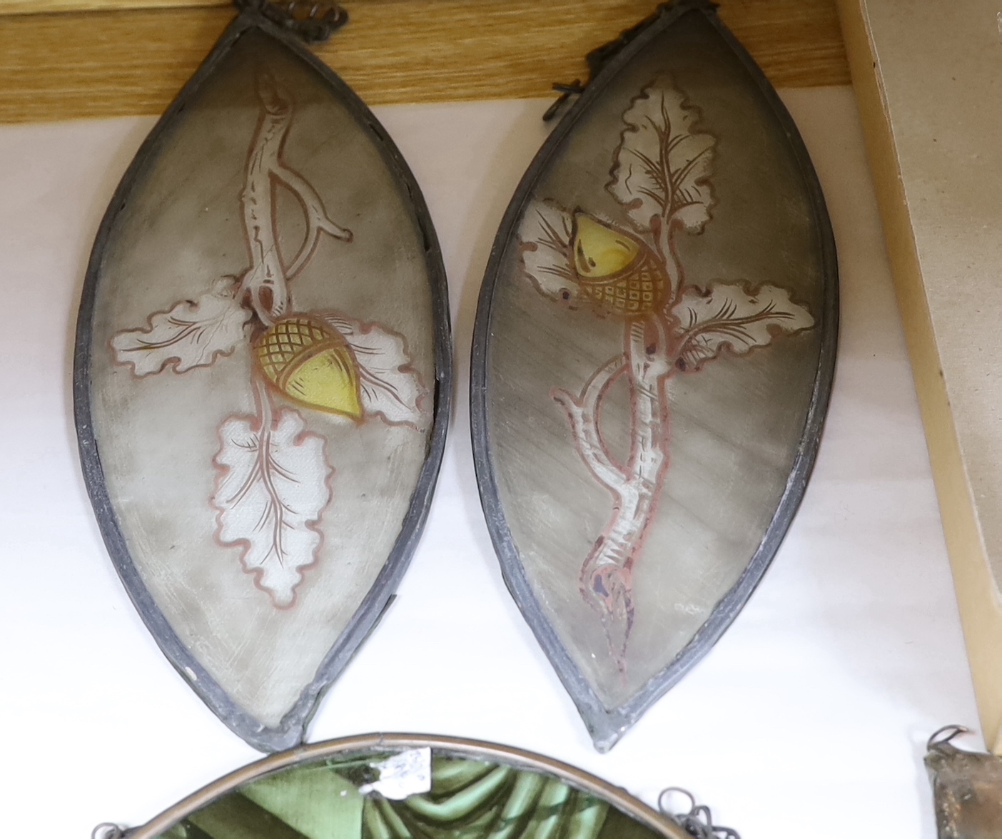 Two panels of early 19th century stained glass, largest 32cm, two tear drop panels, a later panel and a hand blown glass model of a galleon